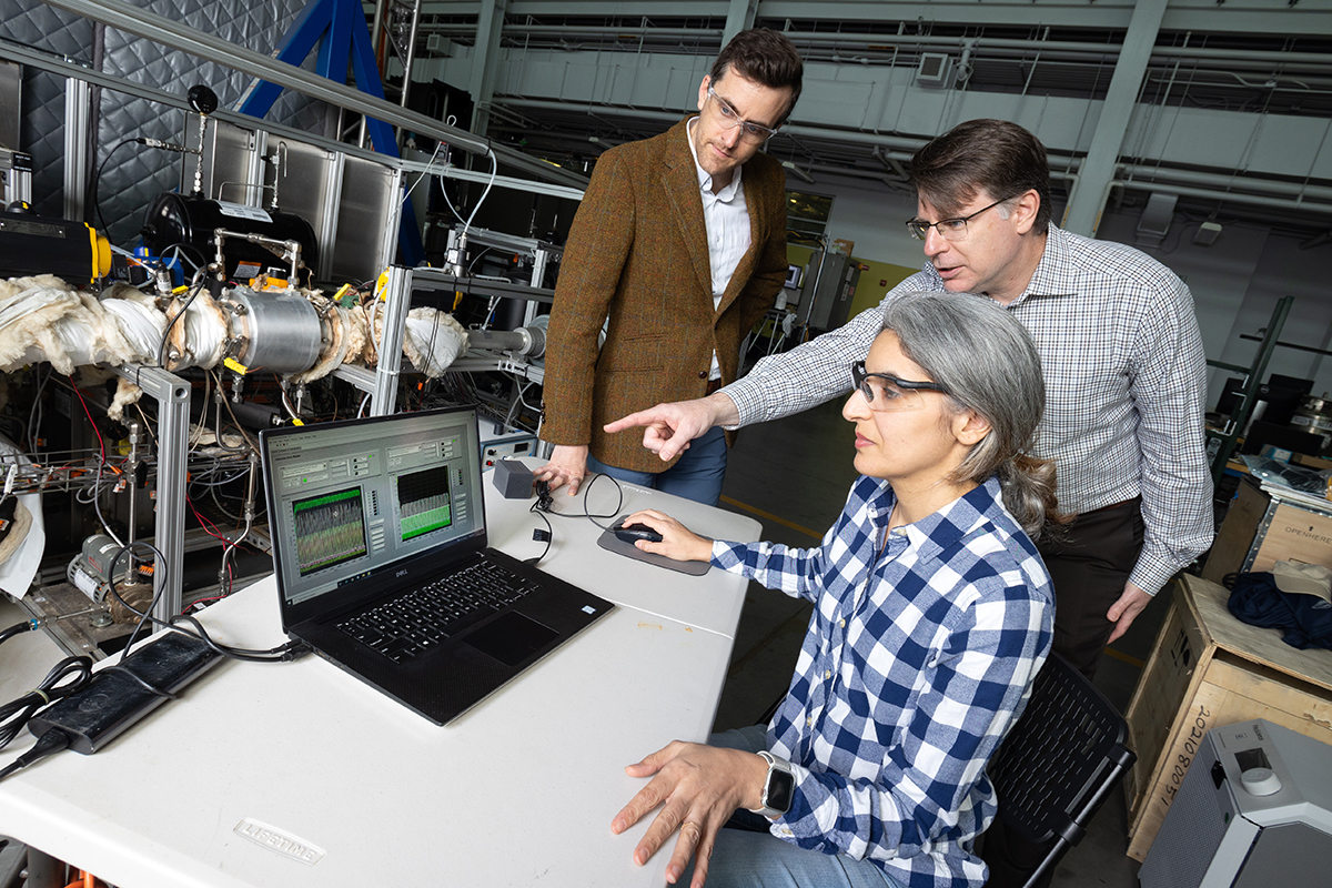 Postdoctoral fellow Poorandokht Kashkouli, seated, discusses test data from their direct air capture rig with Ryan Lively, left, and Chris Jones. The system pulls air across filter materials to remove carbon dioxide. (Photo: Candler Hobbs)