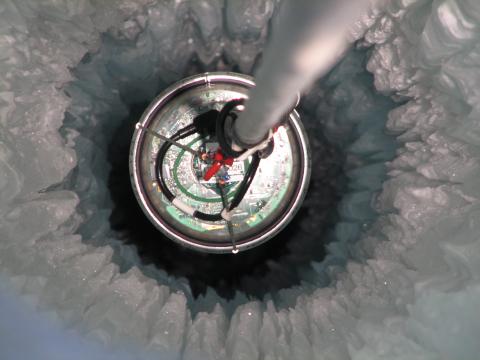 A DOM seen from above as it descends into the array where it can start taking data. (Mark Krasberg, IceCube/NSF)